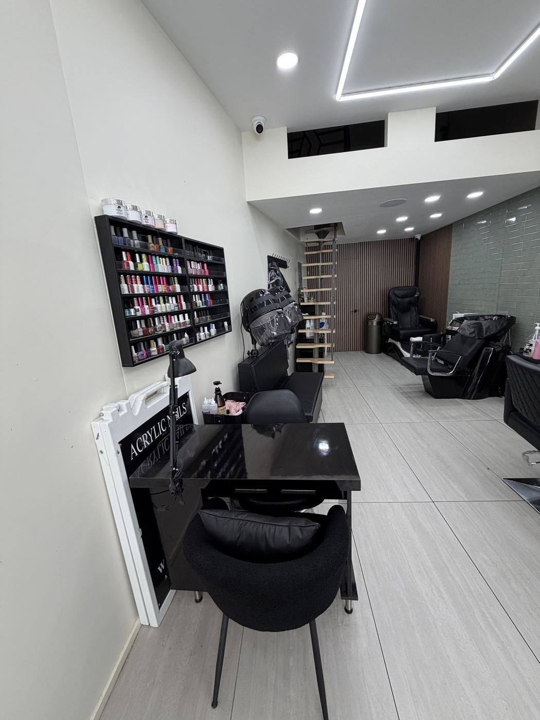 Inside Barber & Blade: nail station, hood dryers and spa room